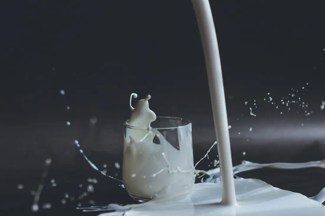 Soy milk being poured from a jug