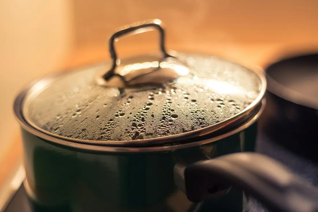 Steam rising from a pot on the stove