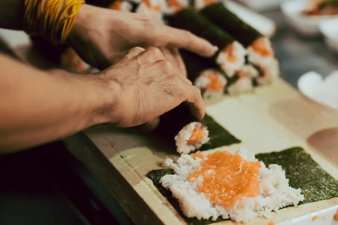 A chef shaping sushi rice by hand