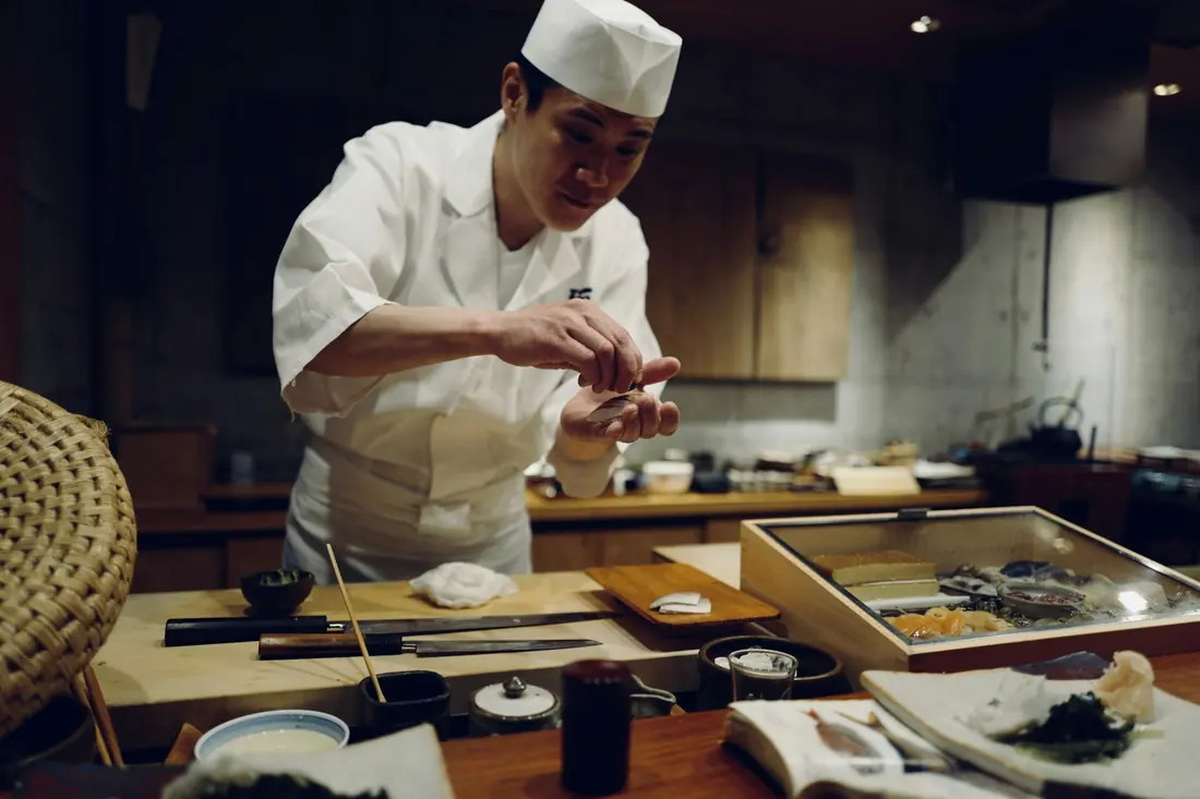 A sushi chef at work behind the counter