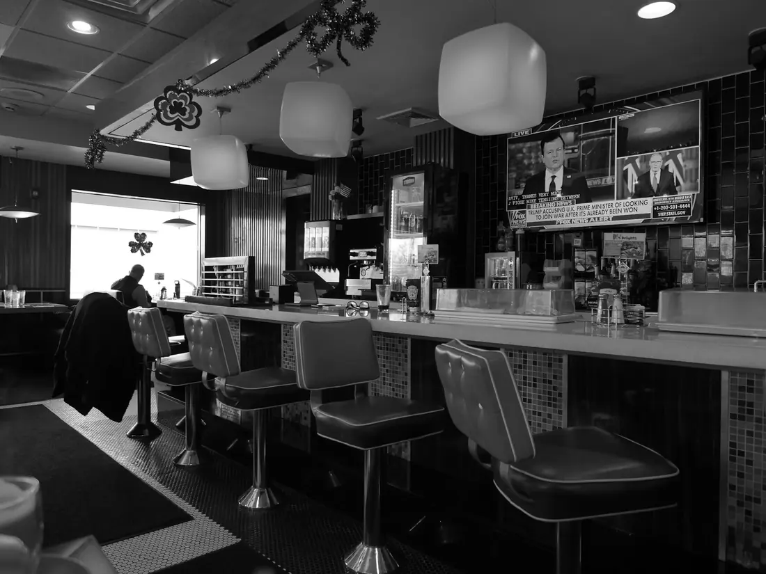 Diners seated at a sushi counter