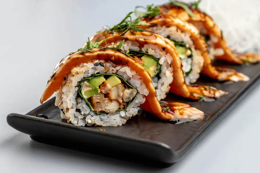 A roll layered with thin slices of salmon across the top