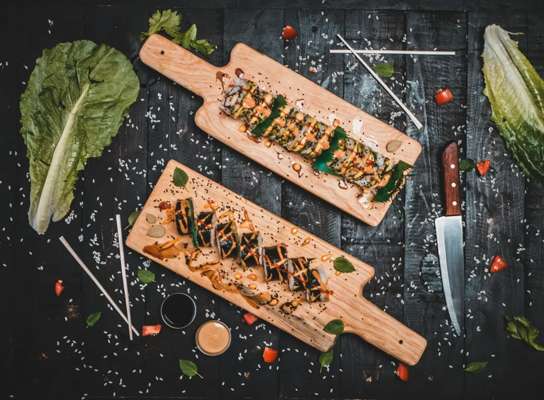 Sushi rolls presented on wooden boards