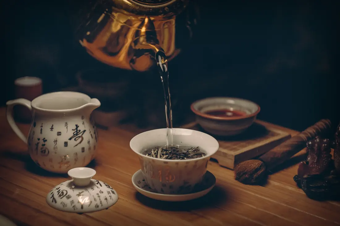 Tea being poured into a small cup