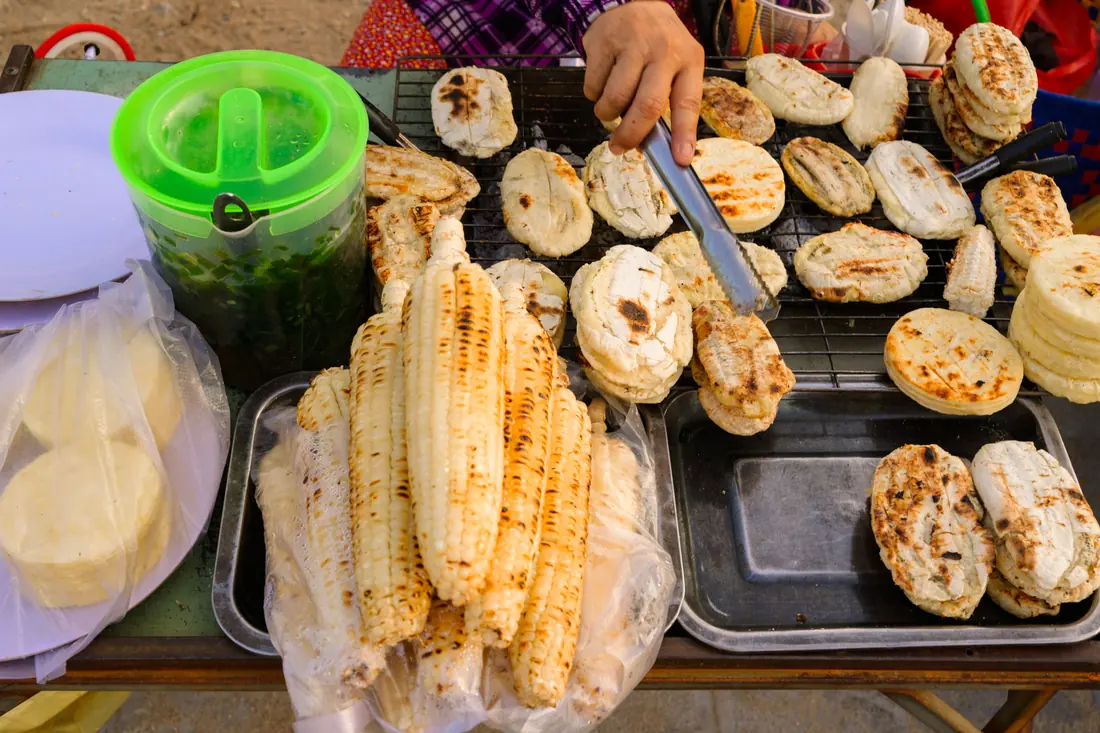 Pale cakes grilling on a street stall