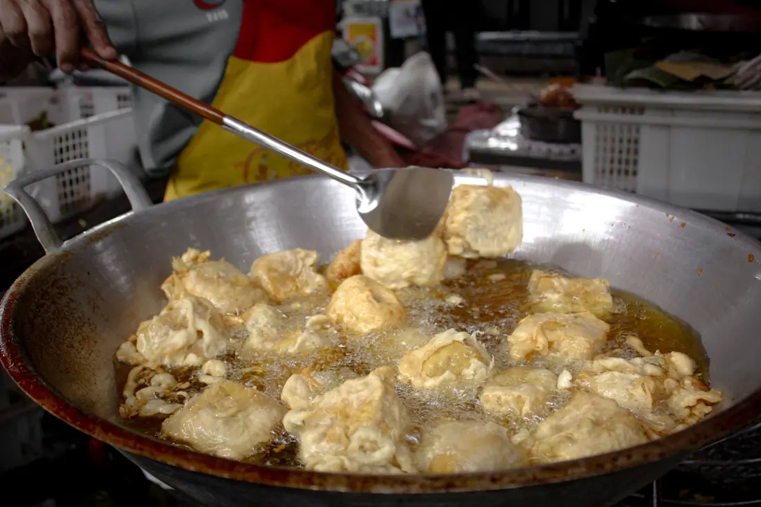 Tofu frying in a pan