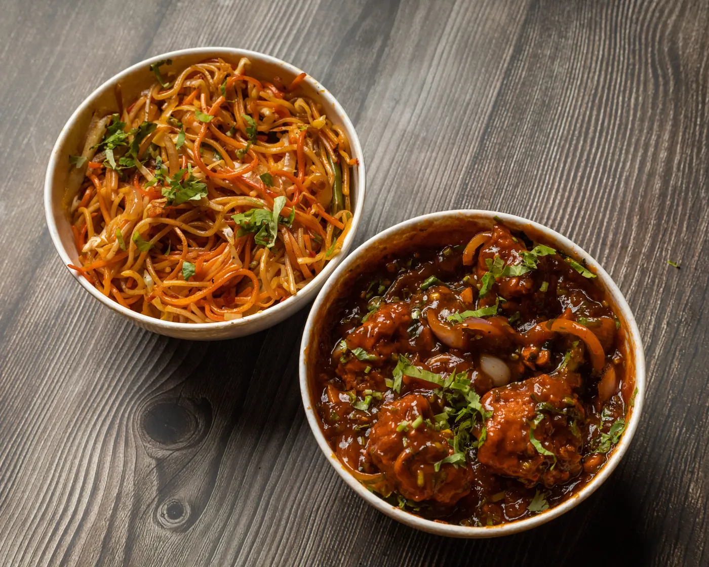Two bowls, noodles and a sauced dish