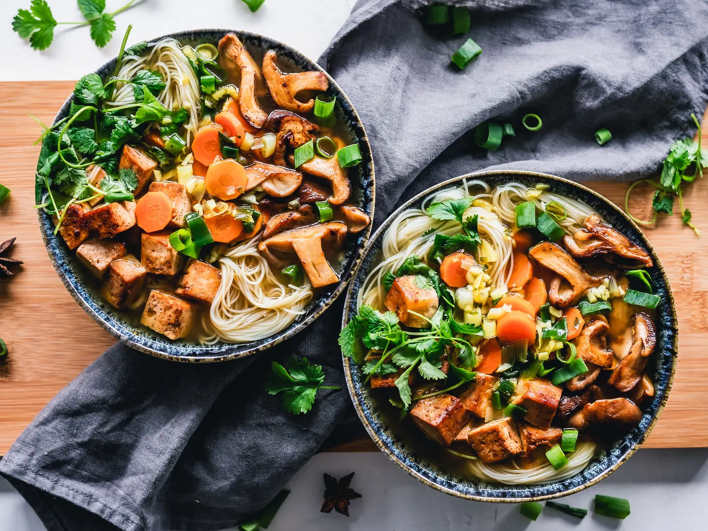 Two bowls of noodle soup, side by side