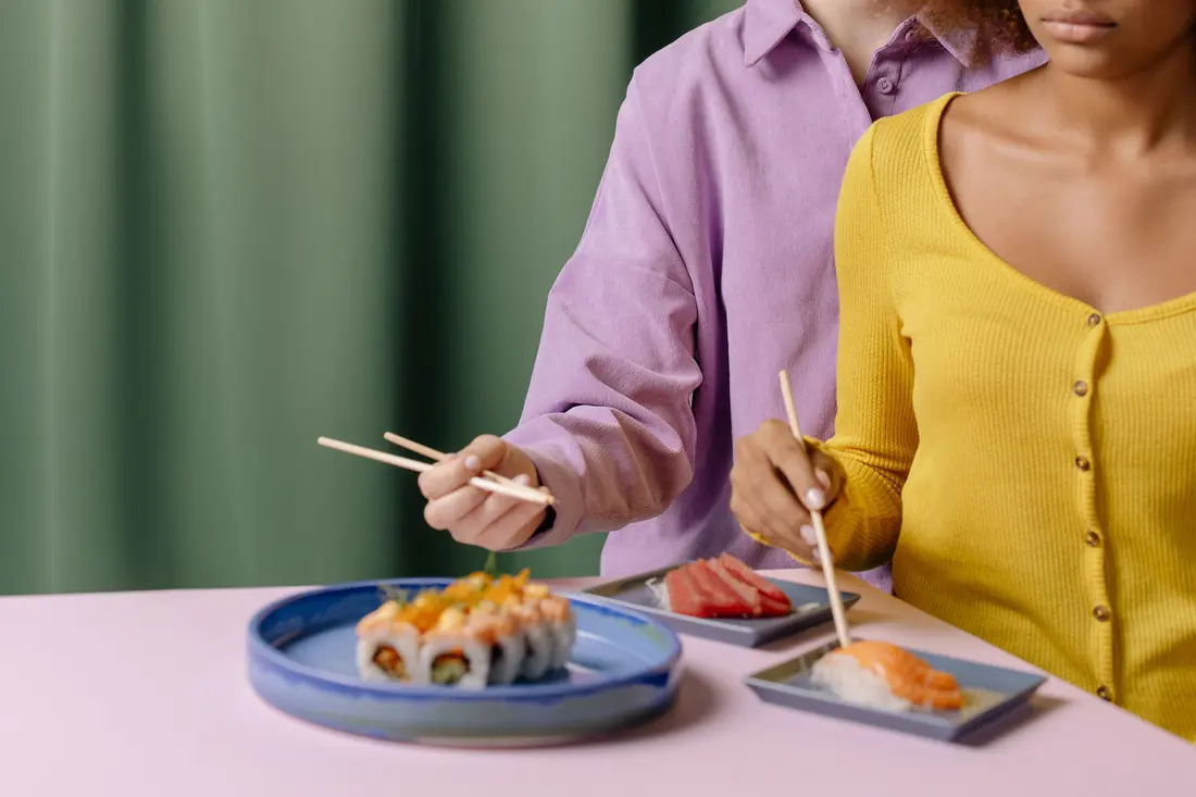 Two people eating together at a table