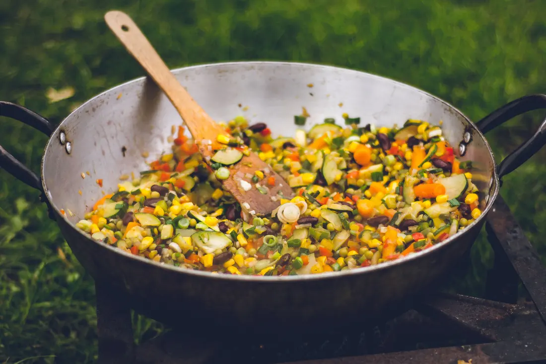 A wide pan of mixed vegetables cooking