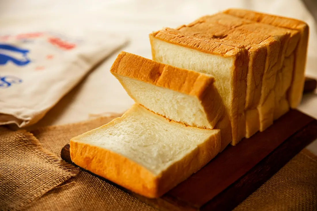 A sliced loaf of soft white bread