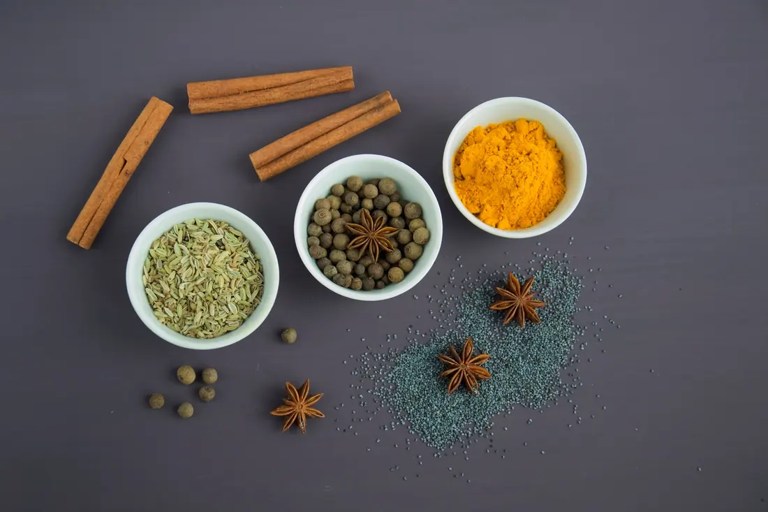 Whole and ground spices in small bowls