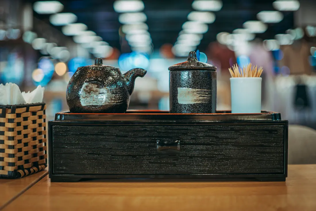 A table caddy holding chopsticks and condiments