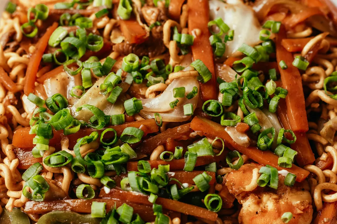 Stir-fried noodles tossed with vegetables and spring onion