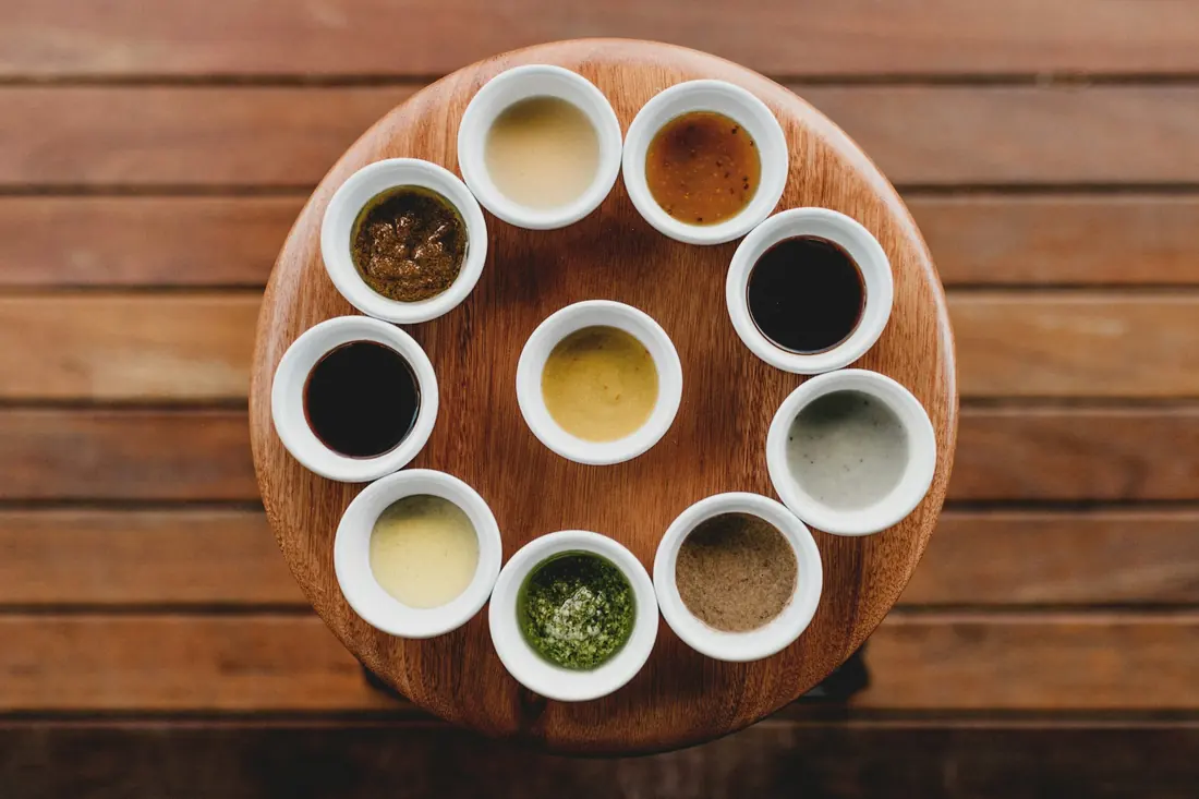 A selection of small dipping sauces in individual cups